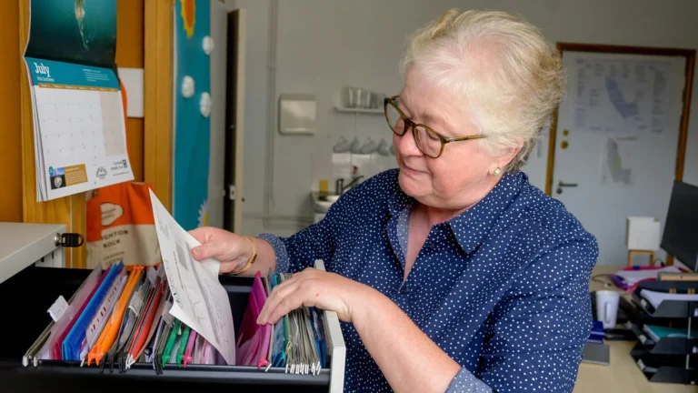 HR manager organising employee benefits information for a small business.